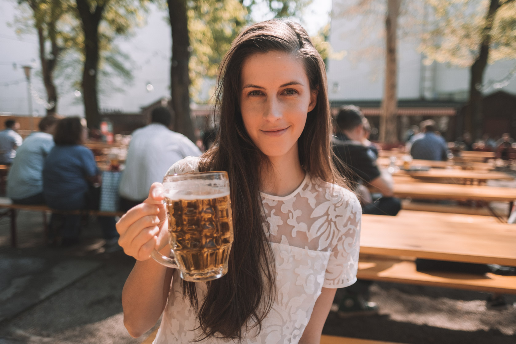 Girl drinking beer at Prater Beer Garden in Berlin