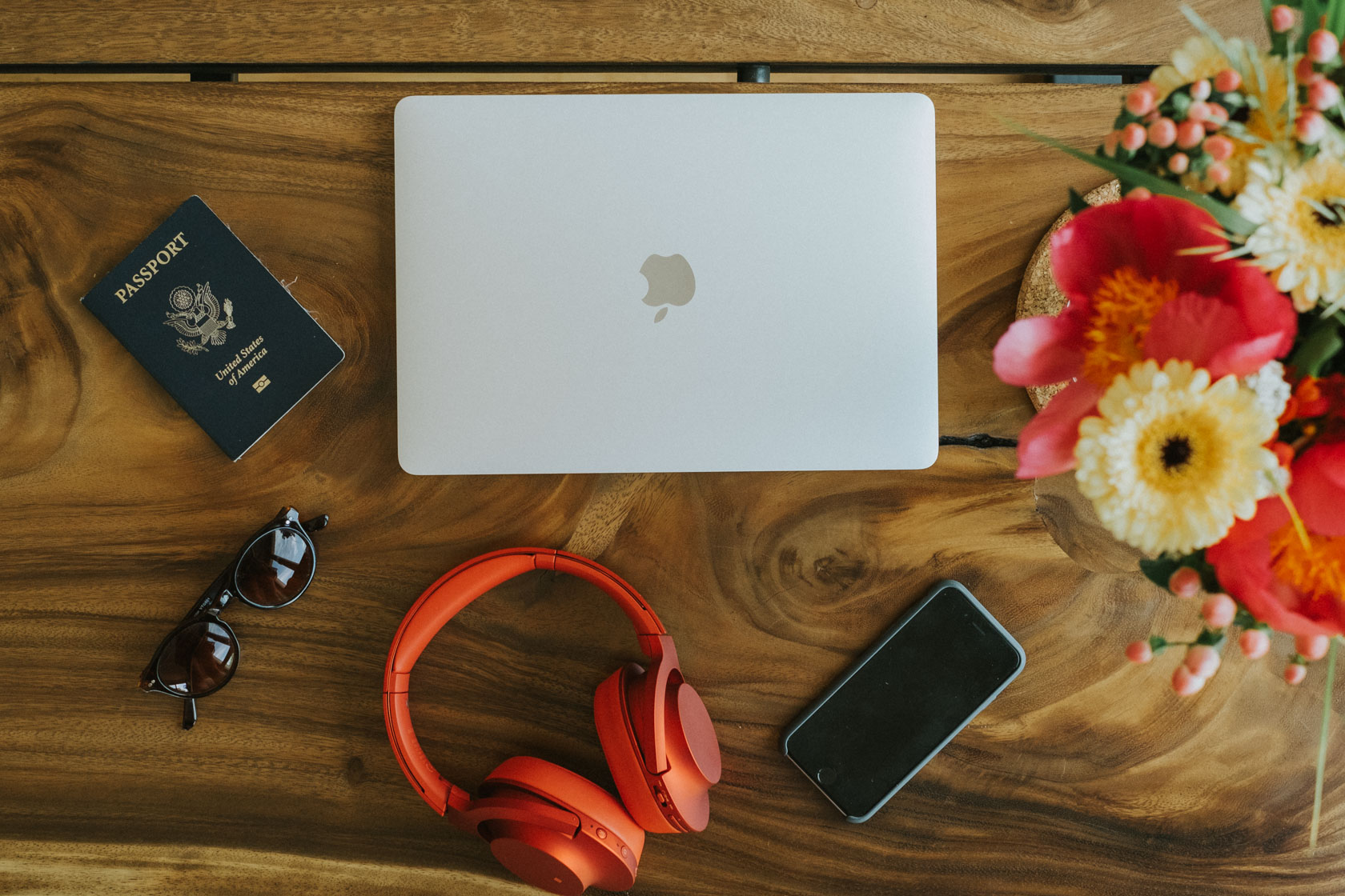 A computer surrounded by travel goods