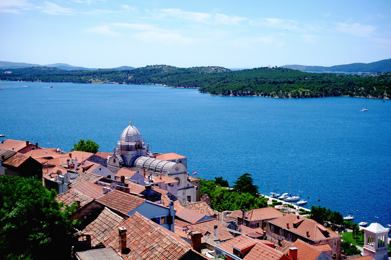 View of the Adriatic Sea from the fortess in Šibenik, Croatia. Below are boats and Croatia's iconic red roofs and St. James' church, famously made without any mortar. View of the Adriatic Sea from the fortess in Šibenik, Croatia. Below are boats and Croatia's iconic red roofs and St. James' church, famously made without any mortar.