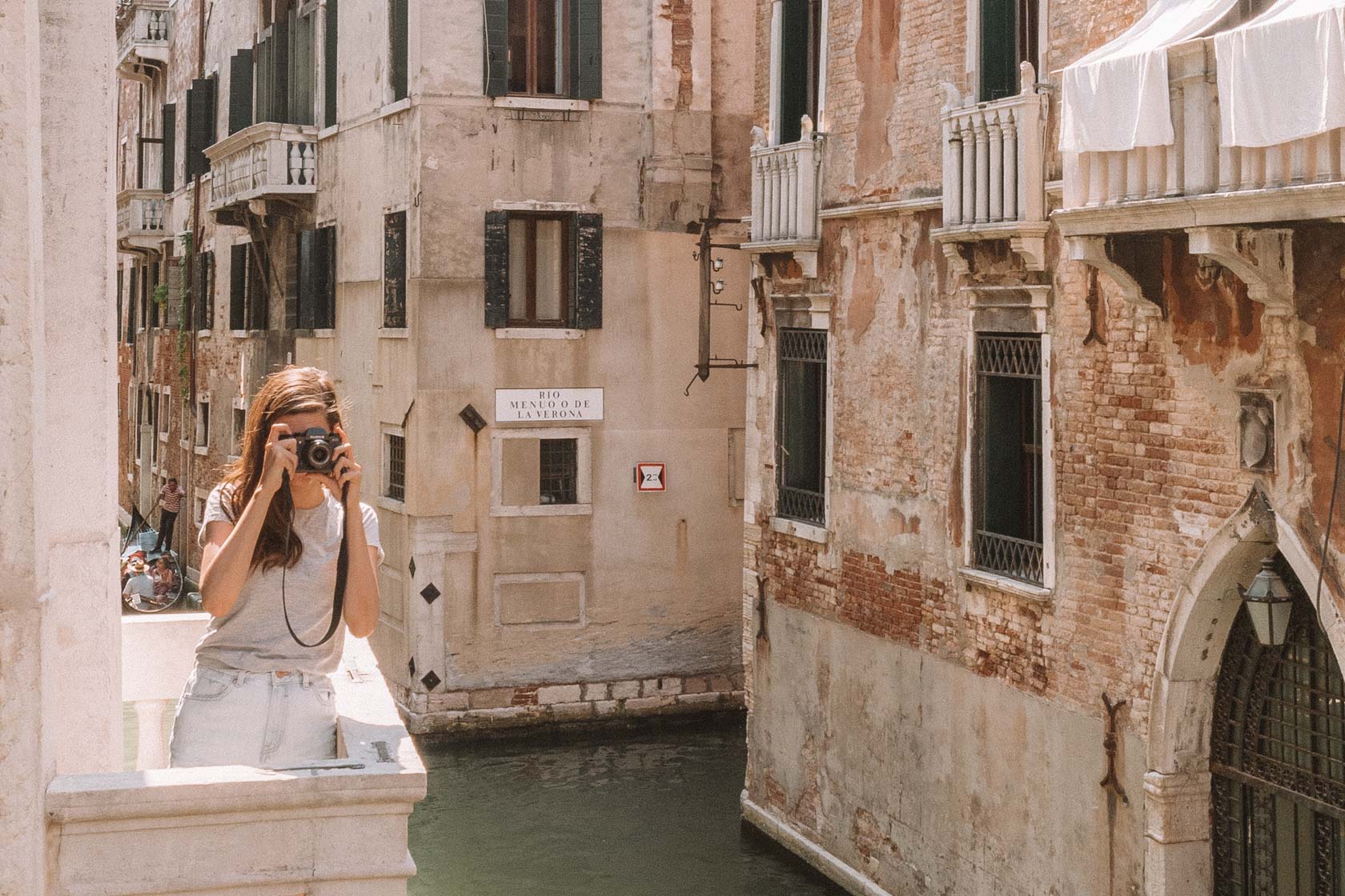 Girl taking a picture in Venice, Italy