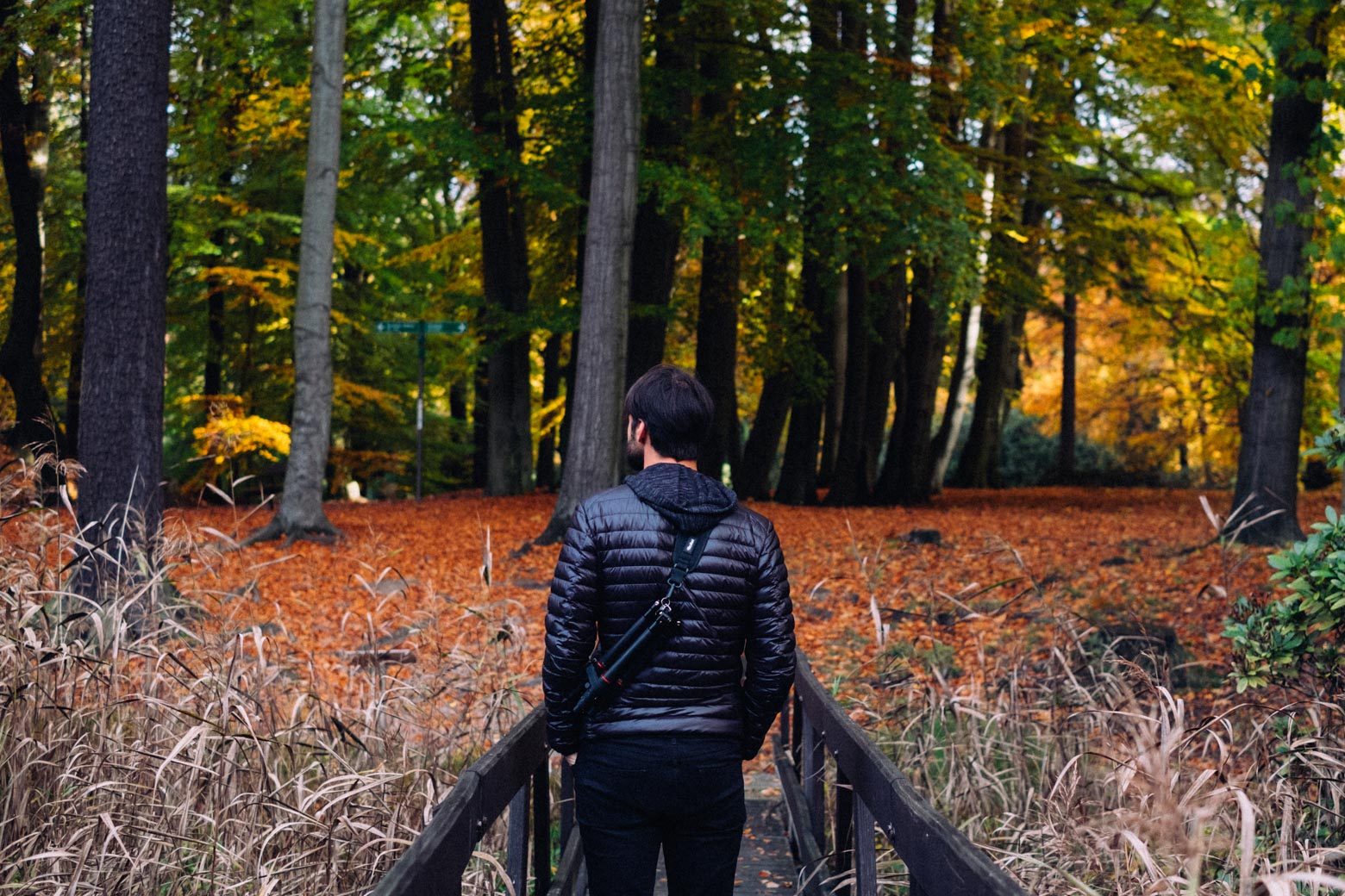 Photo of a man carrying a tripod