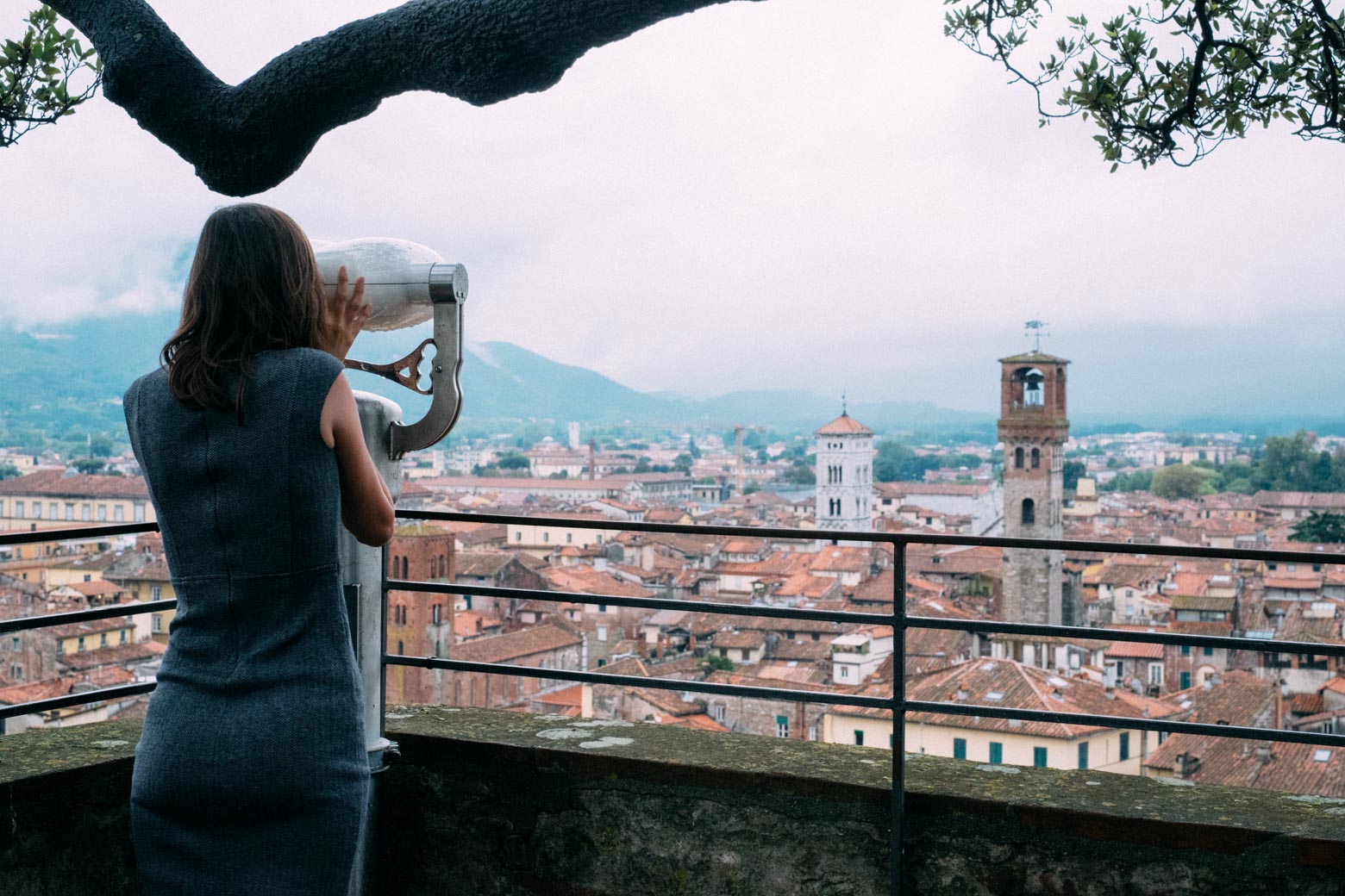 Looking through binoculars from Lucca's tower